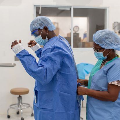 Two medical professionals in protective equipment
