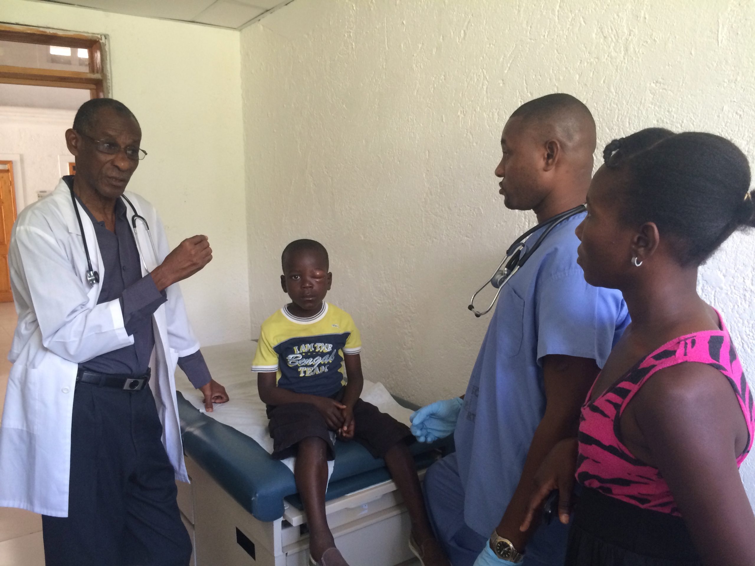 Doctor consulting with parents, with child sitting between them