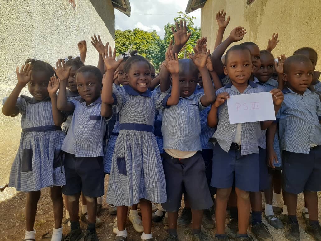 School children with arms raised